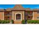 Inviting two-story condo building featuring warm paint, tidy landscaping and a prominent letter 'D' at 12900 Vonn Rd # D202, Largo, FL 33774