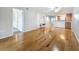 Open-concept living room with hardwood floors, access to other rooms, and a view of the kitchen at 12900 Vonn Rd # D202, Largo, FL 33774