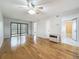Open-plan living space with hardwood floors, balcony access, and an adjoining bathroom at 12900 Vonn Rd # D202, Largo, FL 33774