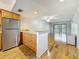 Bright living room with wood floors, ceiling fan, open to the kitchen and leading to a patio at 12900 Vonn Rd # D202, Largo, FL 33774