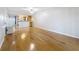 Bright living space with hardwood floors, neutral walls, and kitchen view, offering a versatile living area at 12900 Vonn Rd # D202, Largo, FL 33774