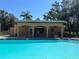 Swimming pool features a cabana with seating and shade, ideal for enjoying sunny days at 12900 Vonn Rd # D202, Largo, FL 33774