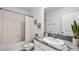 This bathroom has a granite countertop and tiled shower-tub combo at 17261 Bigleaf Mahogany Ln, Land O Lakes, FL 34638