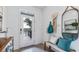 Bright entryway featuring neutral walls, tile floor, decorative mirror, and a decorative bench at 17261 Bigleaf Mahogany Ln, Land O Lakes, FL 34638