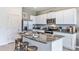 Modern kitchen with granite countertops, stainless steel appliances, kitchen island, and bar stool seating at 17261 Bigleaf Mahogany Ln, Land O Lakes, FL 34638