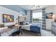 Comfortable bedroom features a desk, large window, and neutral grey color scheme at 17272 Bigleaf Mahogany Ln, Land O Lakes, FL 34638