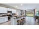 Modern kitchen with granite countertops, stainless steel appliances, and breakfast bar at 17273 Bigleaf Mahogany Ln, Land O Lakes, FL 34638