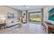 Bright living room with neutral decor and sliding glass doors to the backyard at 17273 Bigleaf Mahogany Ln, Land O Lakes, FL 34638