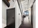 Hallway with dark wood floors leads to the living room with city skyline views beyond at 175 S 2Nd S St # Ph-16, St Petersburg, FL 33701