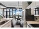 Bright kitchen area features stainless steel appliances, island seating, hardwood floors, and expansive city views from large windows at 175 S 2Nd S St # Ph-16, St Petersburg, FL 33701