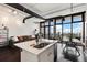 Open-concept living area with a modern kitchen island, exposed ductwork, and a wall of windows offering cityscape views at 175 S 2Nd S St # Ph-16, St Petersburg, FL 33701