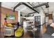 Cozy living room with brick wall, kitchen and stairs, and dark hardwood floors at 175 S 2Nd S St # Ph-16, St Petersburg, FL 33701