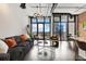 Bright and spacious living room boasting modern decor, floor-to-ceiling windows with city views, and hardwood floors at 175 S 2Nd S St # Ph-16, St Petersburg, FL 33701