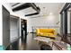 A modern living room boasts sleek dark wood floors, exposed ductwork, and a vibrant yellow sofa at 175 S 2Nd S St # Ph-16, St Petersburg, FL 33701