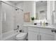 Modern bathroom featuring marble-look tiles, a backlit mirror, and sleek fixtures at 1948 Citrus Hill Ln, Palm Harbor, FL 34683