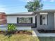 Charming single-story home showcasing white stucco and gray brick with a well-manicured front yard at 1948 Citrus Hill Ln, Palm Harbor, FL 34683
