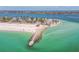 Expansive aerial view showcases a coastal condo building near a sandy beach and the ocean at 200 1St Ave # 309, St Pete Beach, FL 33706