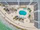 Aerial view of courtyard pool and lounge area nestled within a beachfront condominium at 200 1St Ave # 309, St Pete Beach, FL 33706