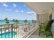Enjoy the beachfront view from this balcony, complete with outdoor seating and a refreshing pool at 200 1St Ave # 309, St Pete Beach, FL 33706