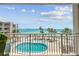 Relax on this balcony with great view of the pool, the ocean, and surrounding landscape at 200 1St Ave # 309, St Pete Beach, FL 33706