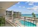 Relax on this balcony with great view of the pool, the ocean, and surrounding landscape at 200 1St Ave # 309, St Pete Beach, FL 33706