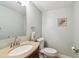 Bathroom with a granite countertop vanity, toilet, and a decorative towel, offering a clean design at 200 1St Ave # 309, St Pete Beach, FL 33706