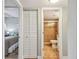 Bathroom with walk-in shower, commode, and sink area with access to bedroom and closet at 200 1St Ave # 309, St Pete Beach, FL 33706
