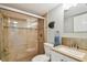 Bathroom with a glass-enclosed shower, modern fixtures, and stylish tiling at 200 1St Ave # 309, St Pete Beach, FL 33706