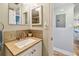 Bathroom vanity with granite countertop, decorative tile backsplash, and modern faucet at 200 1St Ave # 309, St Pete Beach, FL 33706