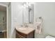 Bathroom featuring vanity with a sink, a mirror with lighting and accessories, offering functionality at 200 1St Ave # 309, St Pete Beach, FL 33706