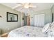 Bedroom featuring stylish decor, hardwood floors, closet, and ceiling fan at 200 1St Ave # 309, St Pete Beach, FL 33706