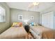 Cozy bedroom featuring two twin beds, a ceiling fan, and a closet, perfect for guests at 200 1St Ave # 309, St Pete Beach, FL 33706