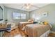 Guest bedroom with twin beds, a window with natural light, and hardwood flooring at 200 1St Ave # 309, St Pete Beach, FL 33706