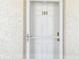 Close-up of the door to the condo, marked with the number 309, and decorative hardware at 200 1St Ave # 309, St Pete Beach, FL 33706