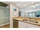 Galley kitchen featuring granite counters, stainless steel appliances and a stainless sink at 200 1St Ave # 309, St Pete Beach, FL 33706