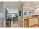 Bright living room with a water view, blue sofa and desk for convenient work space at 200 1St Ave # 309, St Pete Beach, FL 33706