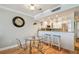 Living room and kitchen view, showing breakfast bar, stainless appliances and water views at 200 1St Ave # 309, St Pete Beach, FL 33706