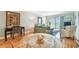 Living room with dining table, desk, comfortable seating and sliding glass doors to a balcony at 200 1St Ave # 309, St Pete Beach, FL 33706