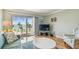 Bright living room featuring a plush sofa and scenic balcony view of the ocean at 200 1St Ave # 309, St Pete Beach, FL 33706