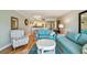 Cozy living room with hardwood floors and blue coastal-themed furniture at 200 1St Ave # 309, St Pete Beach, FL 33706