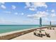 Picturesque ocean view with beach umbrellas and seating area at 200 1St Ave # 309, St Pete Beach, FL 33706