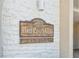 Close-up of the Point Pass-A-Gille sign, with a wood and white brick design at 200 1St Ave # 309, St Pete Beach, FL 33706