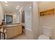 Bright bathroom features a large mirror, shower with curtain, vanity, and tiled floor at 200 4Th S Ave # 220, St Petersburg, FL 33701