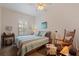 Cozy bedroom with a ceiling fan, wooden rocking chair, and natural light from the window at 200 4Th S Ave # 220, St Petersburg, FL 33701