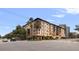 Multi-story condo building with balconies, palm trees, and professional landscaping at 200 4Th S Ave # 220, St Petersburg, FL 33701