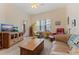 Bright living room with a ceiling fan, modern furnishings, and natural light at 200 4Th S Ave # 220, St Petersburg, FL 33701