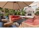 Relaxing patio area with comfortable seating, an outdoor fireplace, and lush greenery at 200 4Th S Ave # 220, St Petersburg, FL 33701