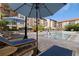 Inviting community pool with lounge chairs and umbrellas for relaxing in the sun at 200 4Th S Ave # 220, St Petersburg, FL 33701