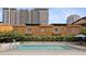 Community pool with well-manicured hedges, clear blue water, and lounge seating at 200 4Th S Ave # 220, St Petersburg, FL 33701
