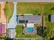Aerial view of home with screened pool, solar panels, fenced yard, and shed at 2013 Capri Rd, Valrico, FL 33594
